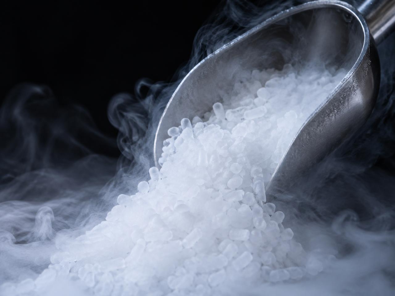 1/8 inch dry ice rice pouring from a stainless scoop